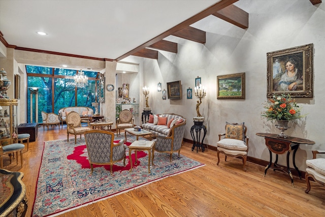 living room featuring vaulted ceiling with beams, crown molding, a chandelier, and light hardwood / wood-style flooring