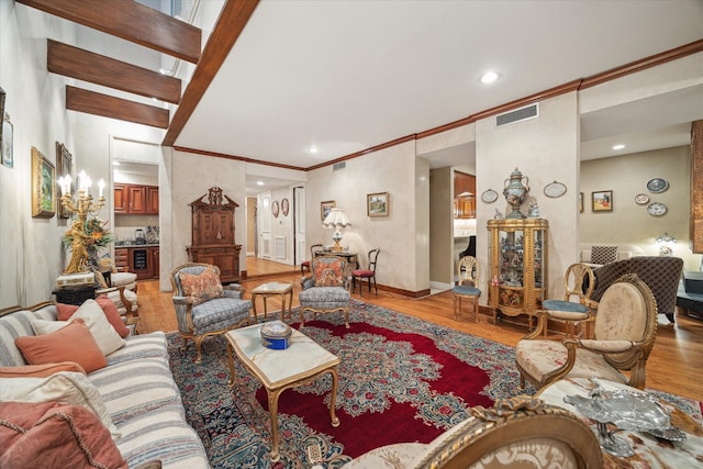 living room featuring hardwood / wood-style flooring and ornamental molding