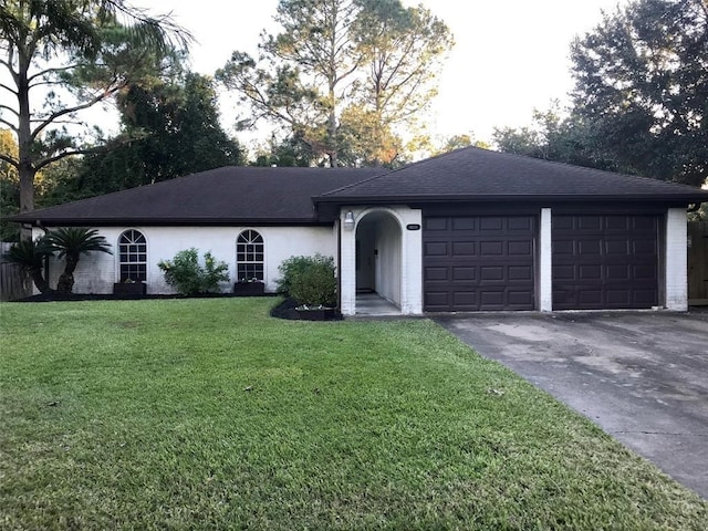 ranch-style house with a garage and a front yard