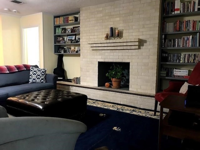 living room with built in features and a brick fireplace