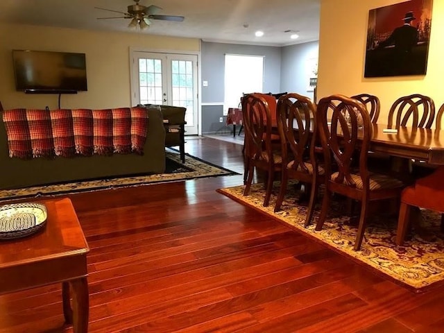 dining room with ceiling fan, french doors, and wood-type flooring