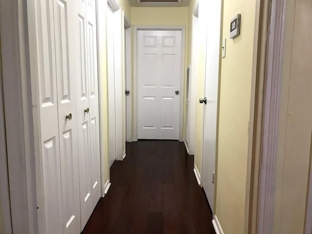 hallway with dark hardwood / wood-style flooring