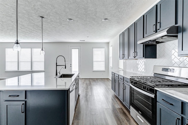 25342 Trinity Oakley Ct, Katy, TX 77493 - kitchen with appliances with stainless steel finishes, under cabinet range hood, a sink, dark wood-type flooring, and backsplash