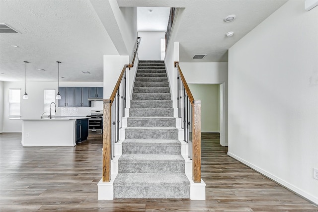 25342 Trinity Oakley Ct, Katy, TX 77493 - staircase featuring wood finished floors and baseboards