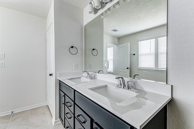 25342 Trinity Oakley Ct, Katy, TX 77493 - bathroom with double vanity, baseboards, and tile patterned floors