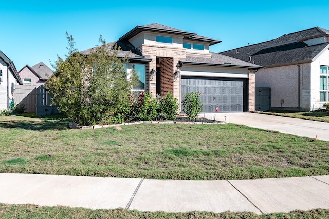 view of front of house with a garage and a front yard