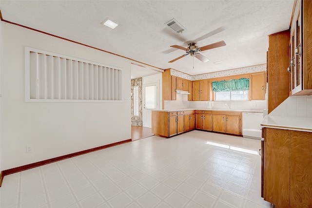 kitchen featuring white dishwasher, ceiling fan, sink, and a textured ceiling