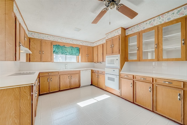 kitchen with a textured ceiling, white appliances, ceiling fan, and sink