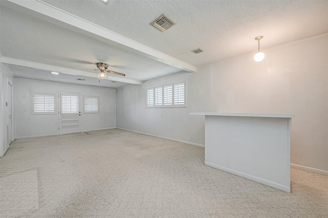 spare room featuring ceiling fan, plenty of natural light, and a textured ceiling