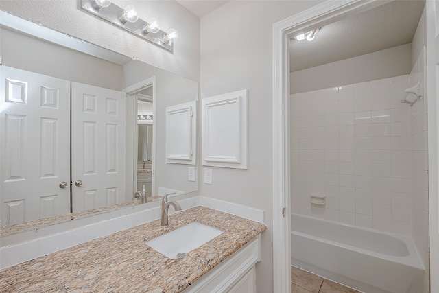 bathroom featuring tile patterned floors, shower / washtub combination, and vanity