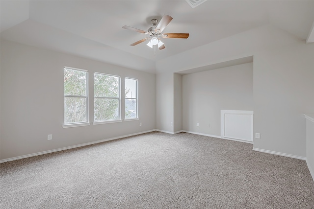 carpeted spare room featuring ceiling fan and vaulted ceiling