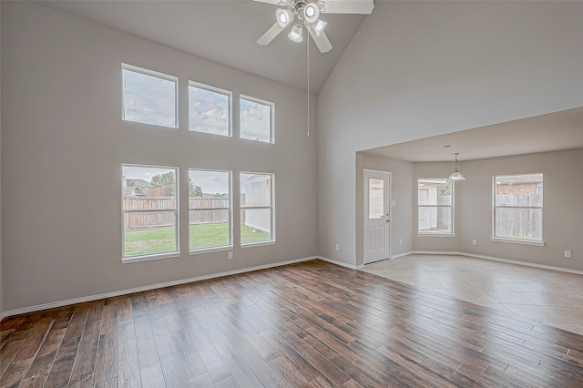 interior space featuring light hardwood / wood-style floors, high vaulted ceiling, and ceiling fan