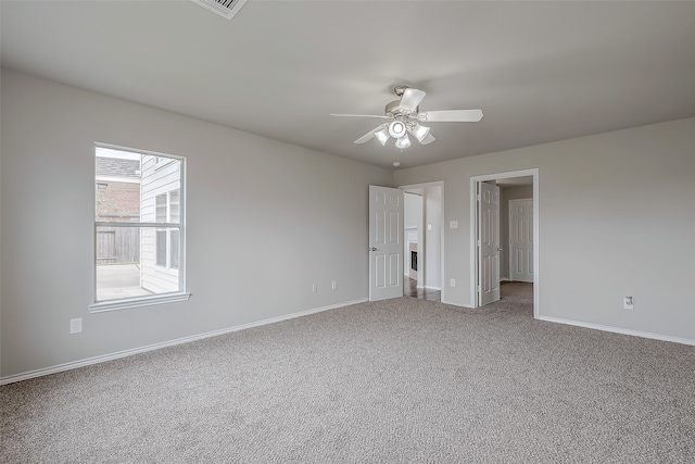 spare room with carpet and ceiling fan