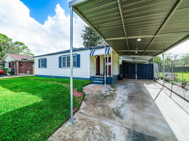 view of front of property with a front lawn and a carport