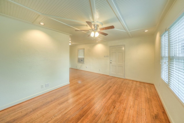 unfurnished room featuring a healthy amount of sunlight, crown molding, and light hardwood / wood-style flooring