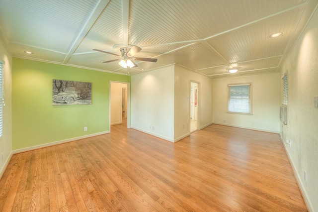 empty room with ornamental molding, baseboards, ceiling fan, and light wood finished floors