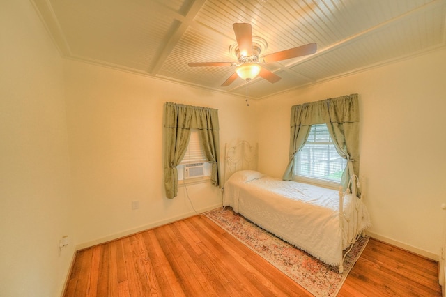 unfurnished bedroom with ceiling fan, wooden ceiling, crown molding, cooling unit, and hardwood / wood-style flooring