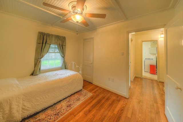 bedroom with light wood-style floors, ceiling fan, baseboards, and washer / dryer