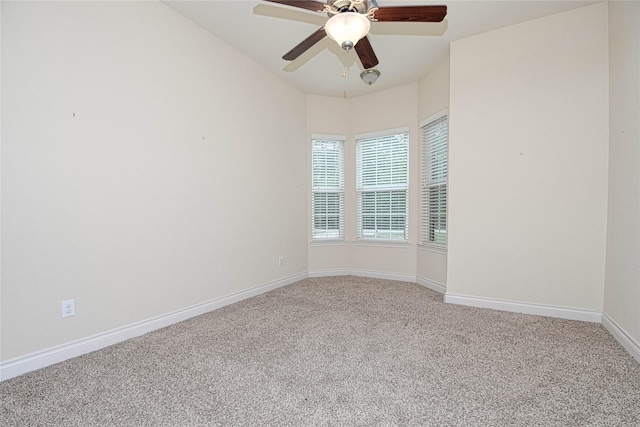 spare room featuring ceiling fan and carpet