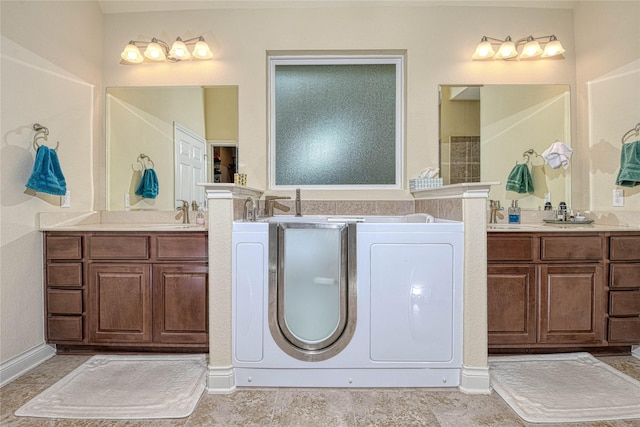 bathroom with washing machine and dryer and vanity