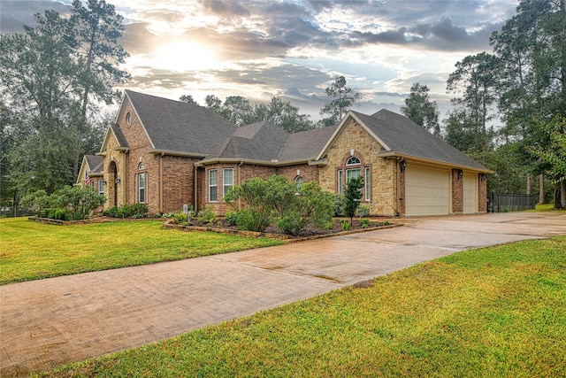 view of front of property with a yard and a garage