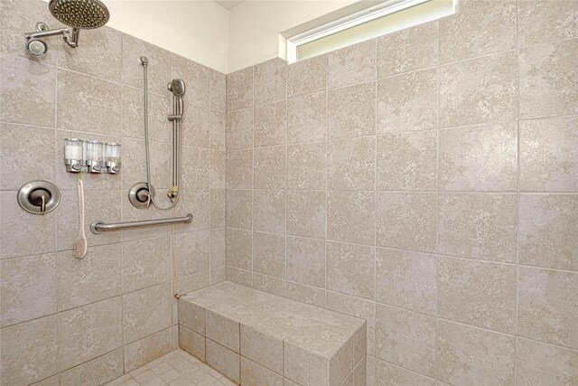 bathroom with a tile shower