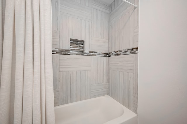 bathroom with shower / tub combo with curtain