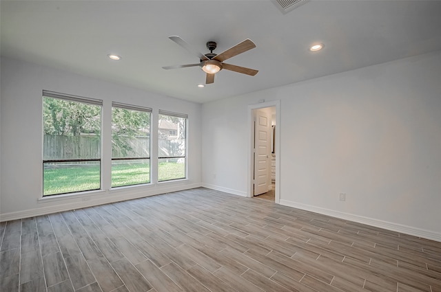 empty room with light hardwood / wood-style flooring and ceiling fan