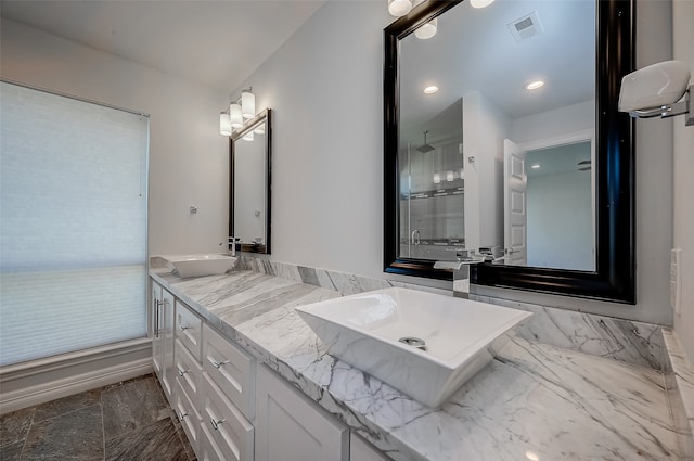 bathroom featuring vanity and an enclosed shower