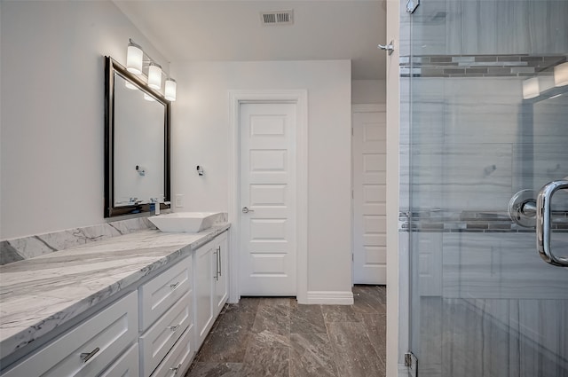 bathroom featuring vanity and an enclosed shower