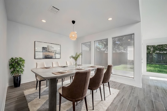 dining space with wood-type flooring