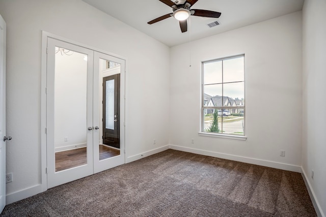 carpeted empty room featuring french doors and ceiling fan