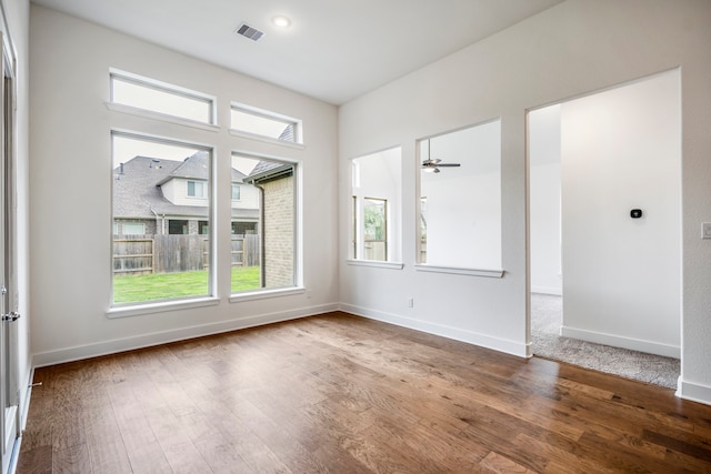 empty room featuring hardwood / wood-style floors and ceiling fan