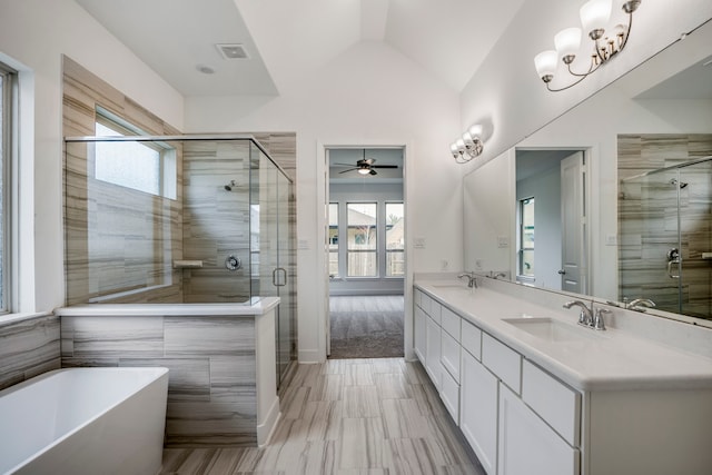 bathroom with vanity, vaulted ceiling, ceiling fan, and separate shower and tub