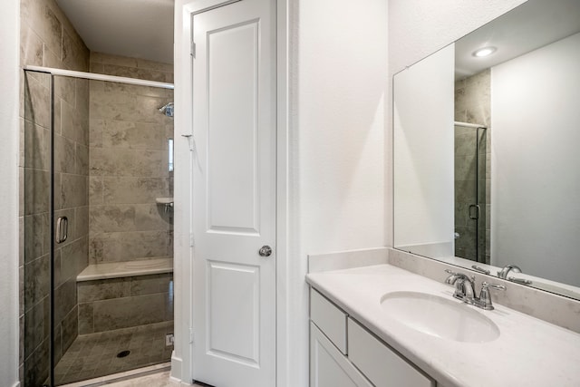 bathroom featuring vanity and a shower with shower door