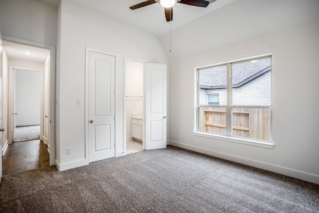 unfurnished bedroom with carpet floors, ceiling fan, lofted ceiling, and connected bathroom