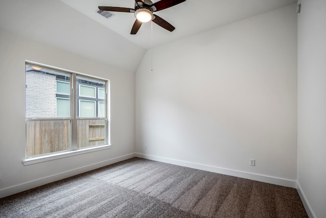 spare room with ceiling fan, carpet floors, and vaulted ceiling