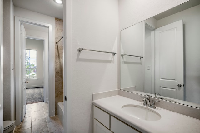 bathroom with tile patterned floors, vanity, and toilet