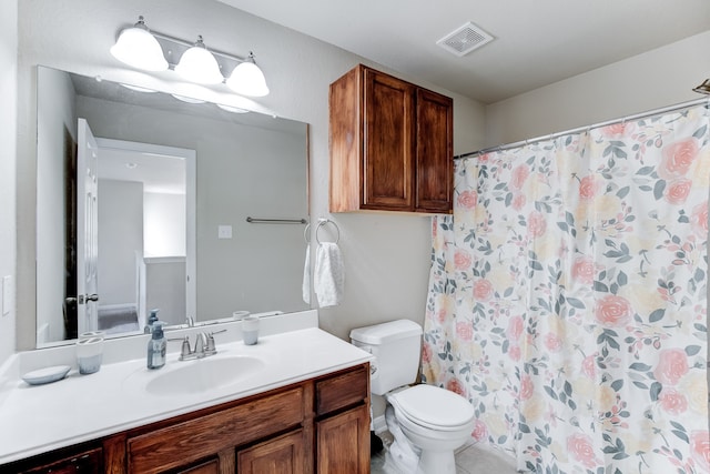 bathroom featuring tile patterned flooring, vanity, and toilet