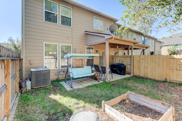 back of property featuring cooling unit and a patio area