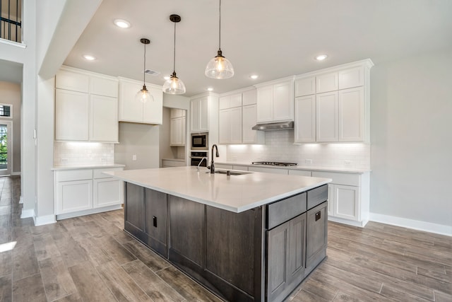 kitchen featuring white cabinets, sink, appliances with stainless steel finishes, and light hardwood / wood-style flooring