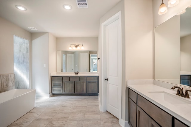 bathroom with vanity and a bath