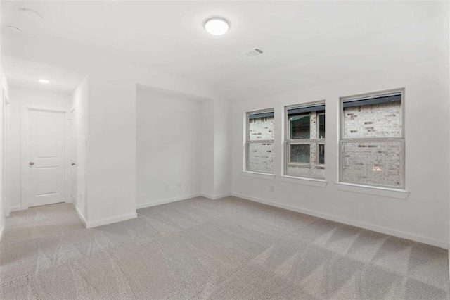 carpeted empty room featuring a wealth of natural light