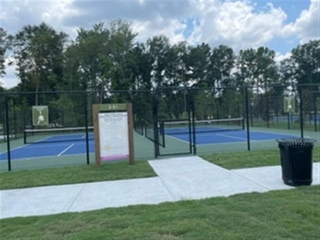 view of sport court featuring a yard