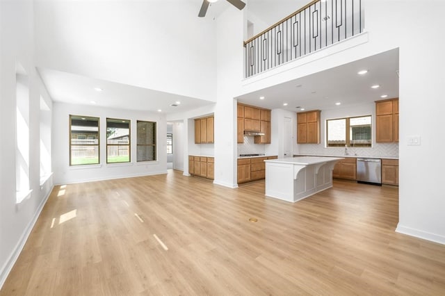 7427 Cattail Falls Ln, Porter, TX 77365 - unfurnished living room with a ceiling fan, light wood finished floors, a sink, baseboards, and recessed lighting