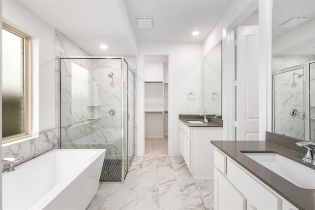 7427 Cattail Falls Ln, Porter, TX 77365 - full bathroom with a marble finish shower, marble look tile flooring, recessed lighting, a soaking tub, and two vanities