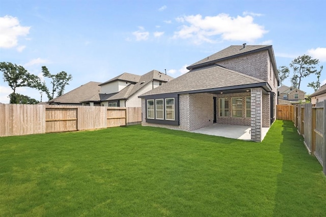 7427 Cattail Falls Ln, Porter, TX 77365 - rear view of property with brick siding, a shingled roof, and a patio area