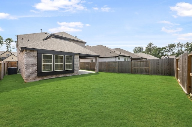 7427 Cattail Falls Ln, Porter, TX 77365 - back of property featuring brick siding, a shingled roof, and central air condition unit