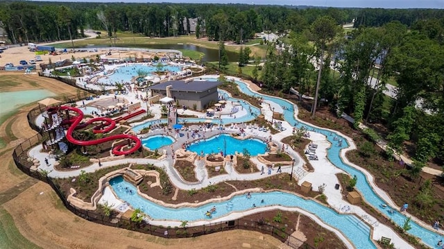 7427 Cattail Falls Ln, Porter, TX 77365 - aerial view of property's location featuring a pool area, a heavily wooded area, and a nearby body of water