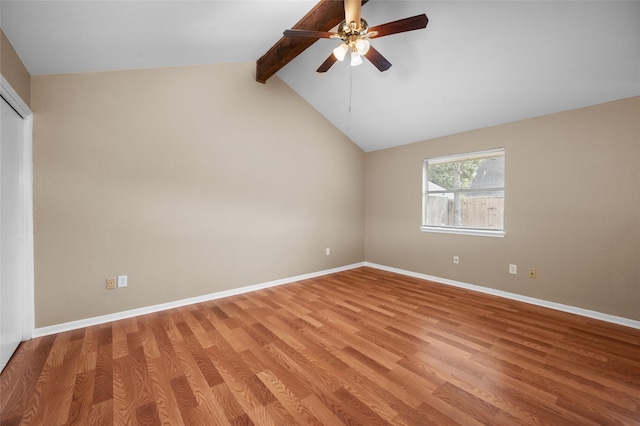 spare room with vaulted ceiling with beams, ceiling fan, and light wood-type flooring